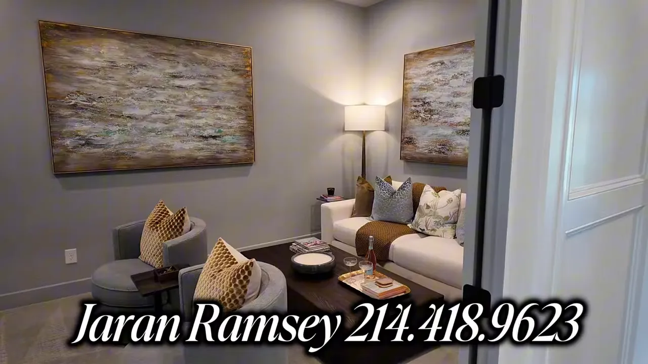 Boutique luxury seating area with sofas, wall art, and decorative pillows in the Estates at Bristol Valley model home