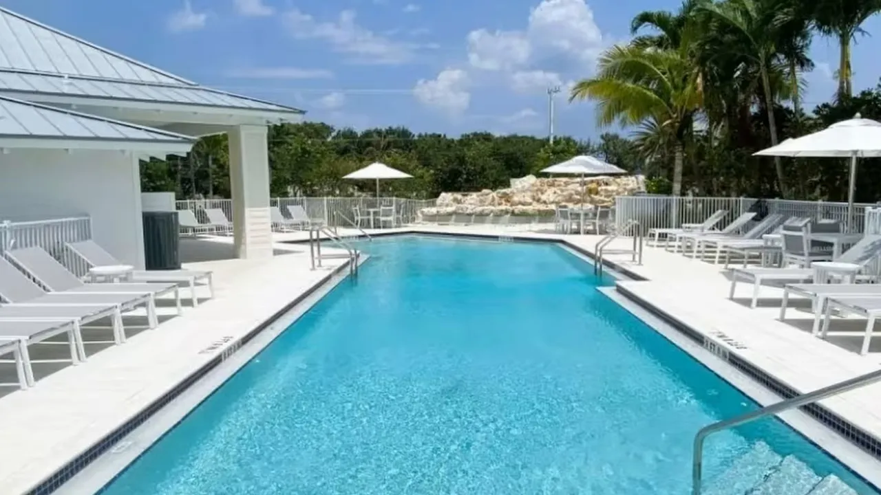 rendering of resort style pool with lounge chairs at the reserve at tequesta