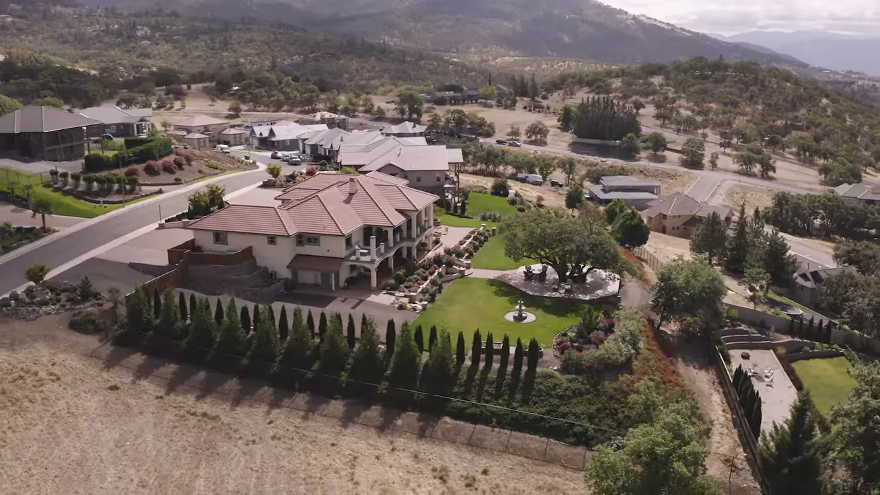 Aerial view of a premium East Medford hillside neighborhood with large homes and landscaped yards