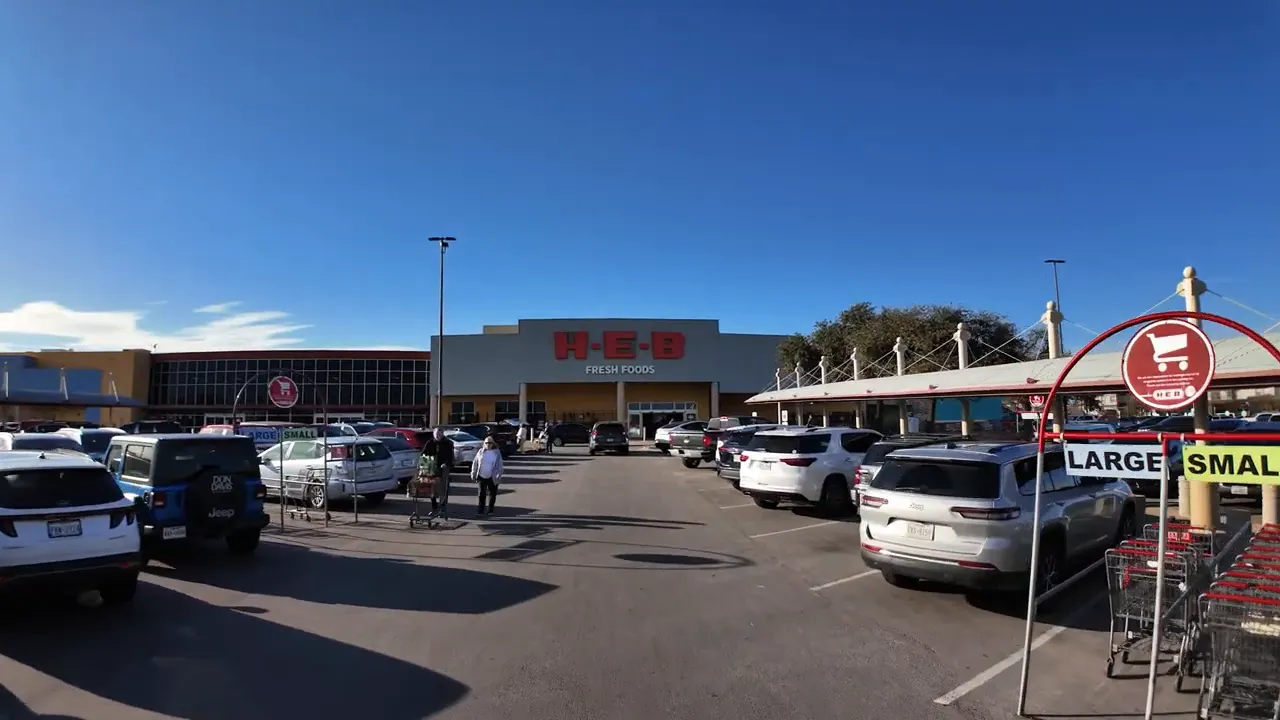 View of an H-E-B store with parking and shopping carts in Round Rock Texas
