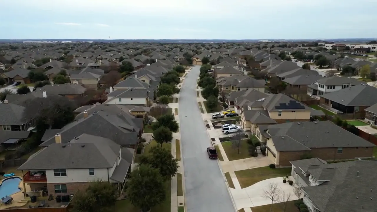 Aerial view of a Round Rock Texas neighborhood with houses lining residential streets