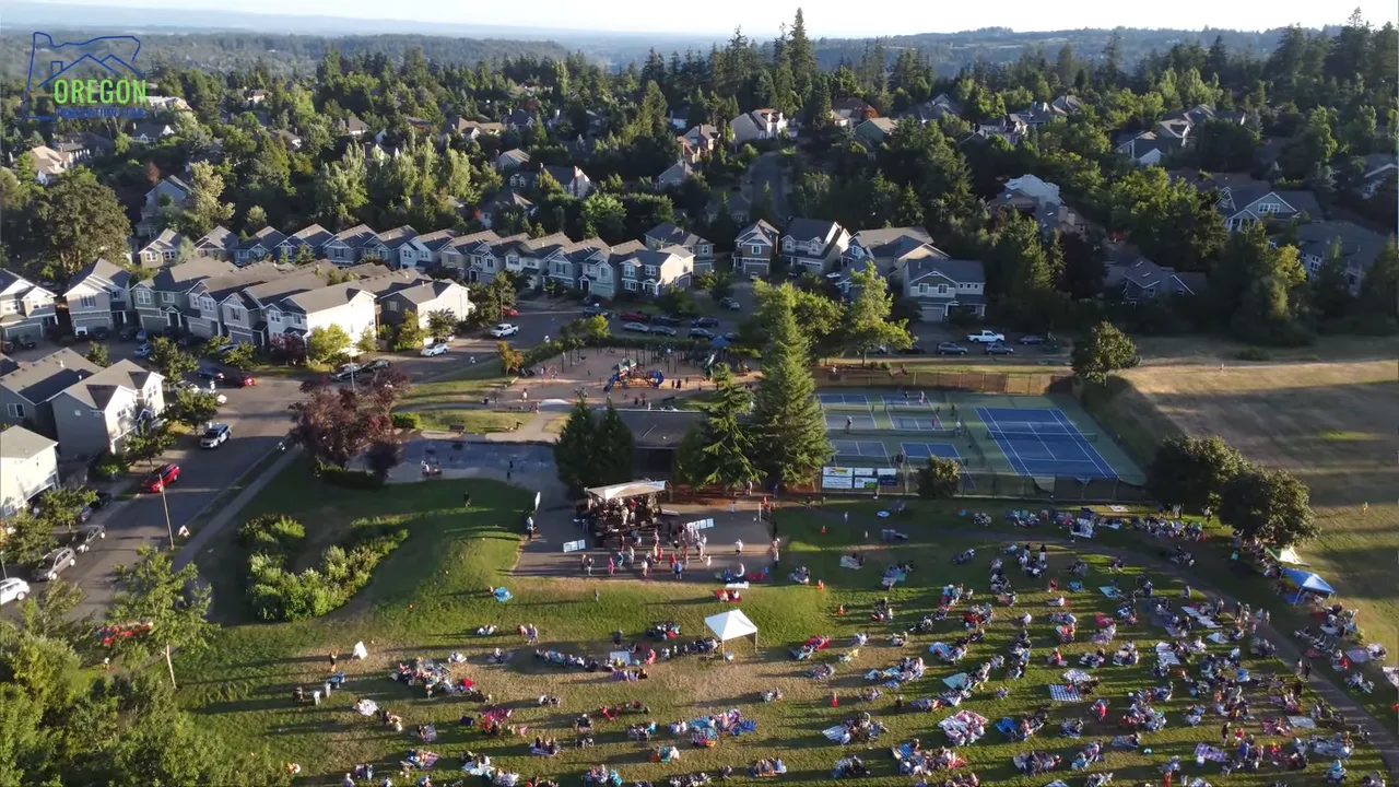 Aerial view of an Oregon neighborhood with outdoor event seating on a lawn