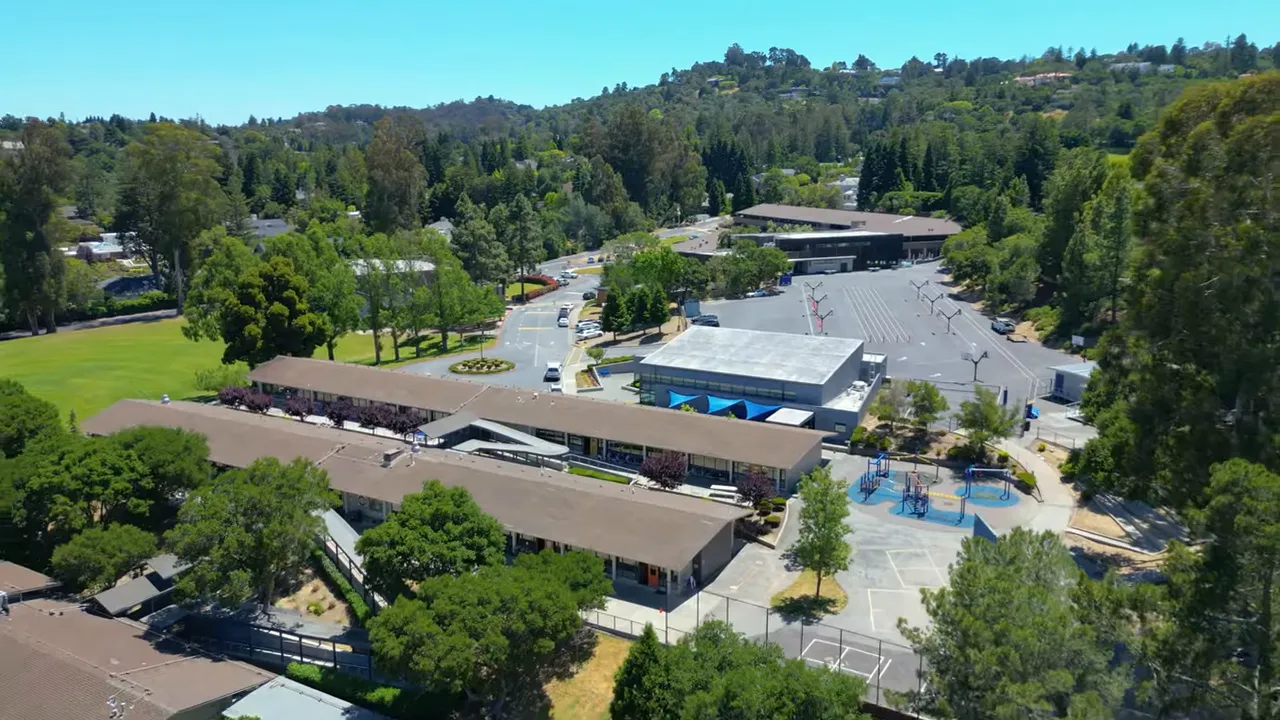 Aerial view of a school campus and parking area