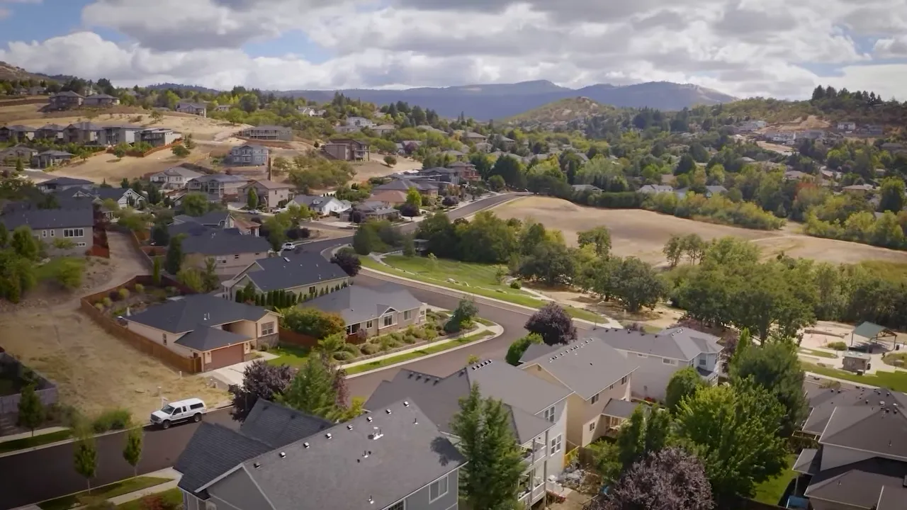 Aerial view of neighborhoods in Southern Oregon with homes and hills