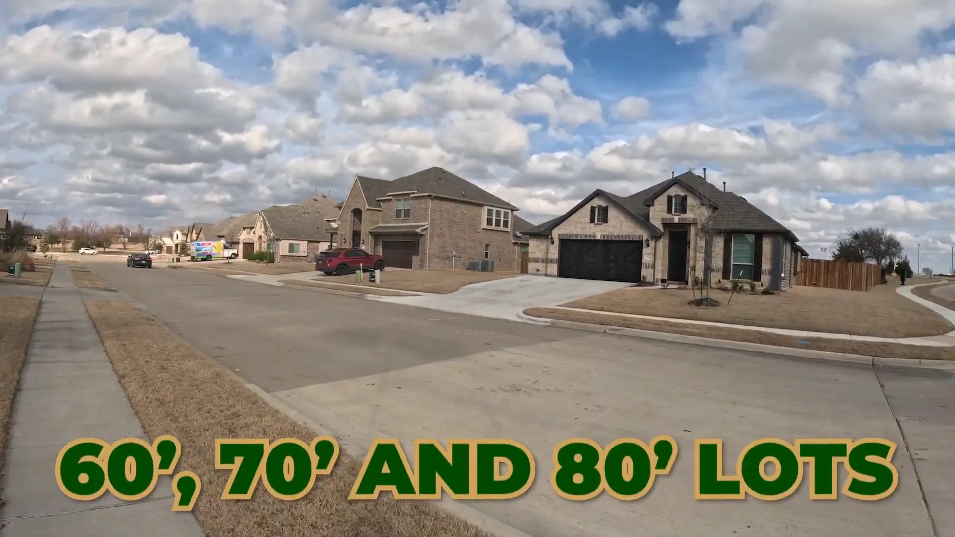 Wide residential street with large homes at Stone River