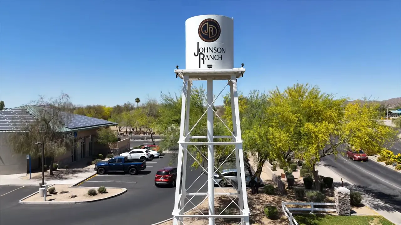 Johnson Ranch water tower sign above neighborhood entrance area and parking lot