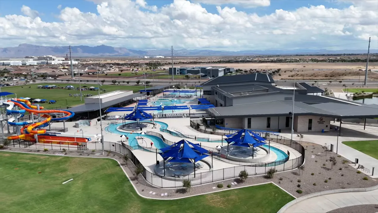 large water park complex with pools slides and shaded structures