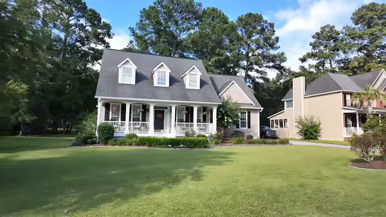 Lowcountry style home and front porch with manicured landscaping at Legend Oaks Plantation in Summerville SC