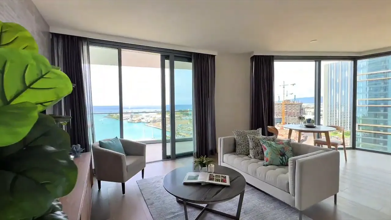 Modern living room with large floor-to-ceiling windows and ocean view from Kaka‘ako condo