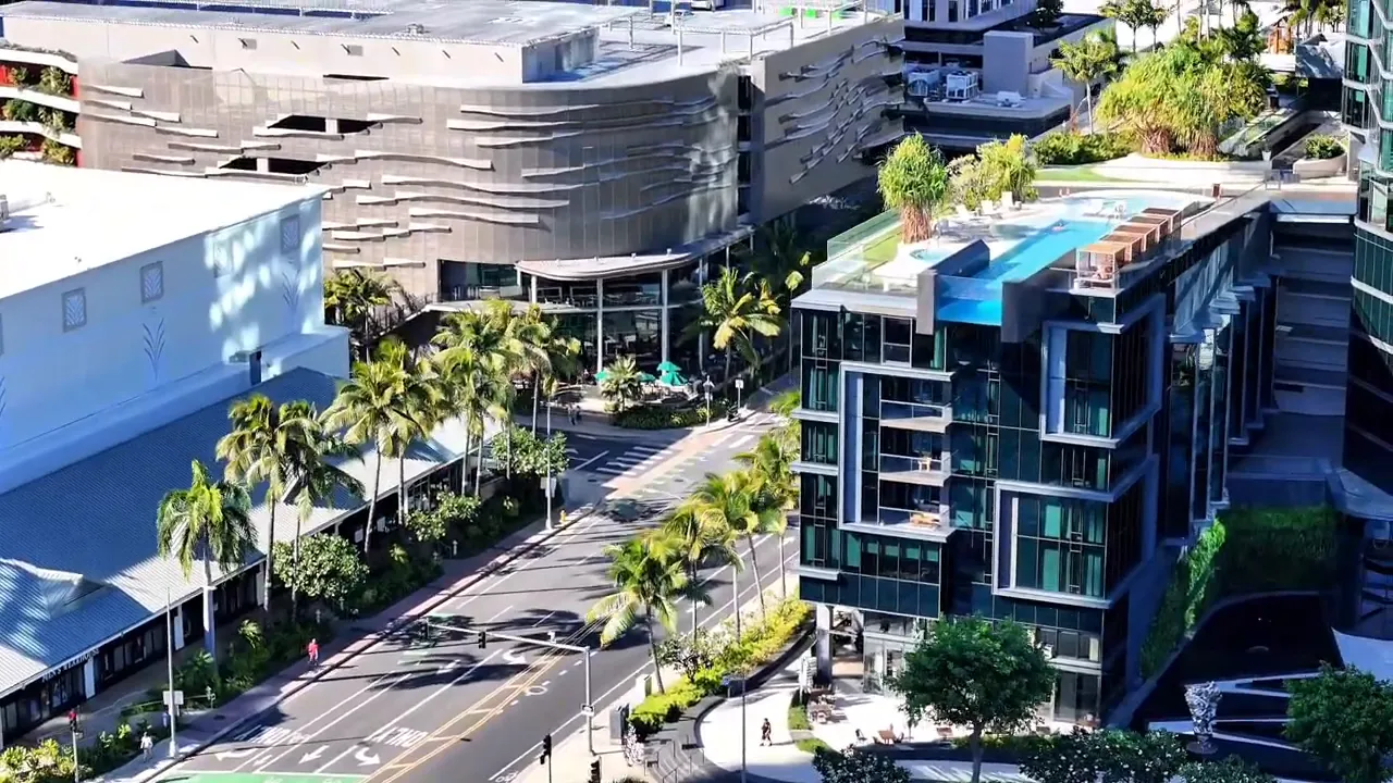 Aerial view of modern Kaka‘ako Honolulu building with pool and landscaped courtyard