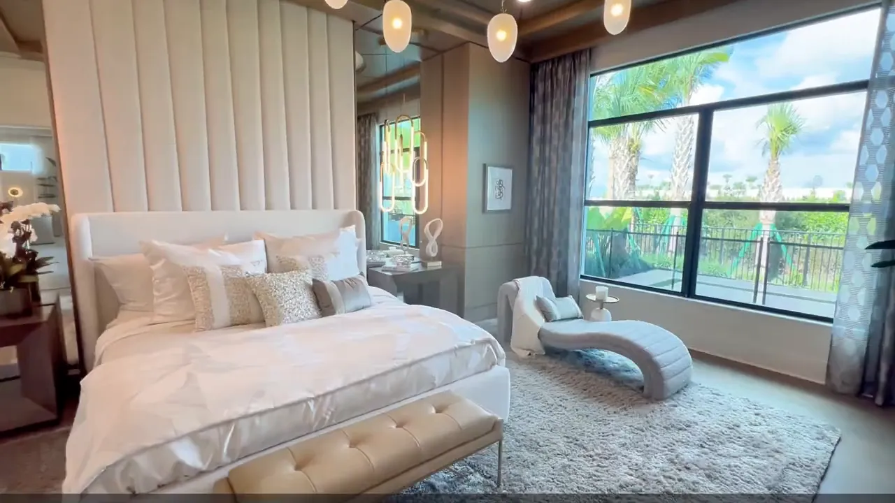 Sophia owner suite with upholstered bed large windows and chaise lounge
