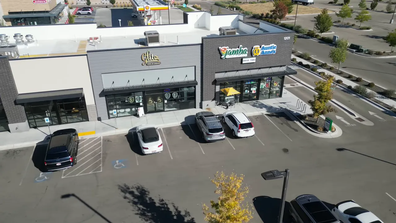 Intersection scene in Meridian showing local shops and traffic