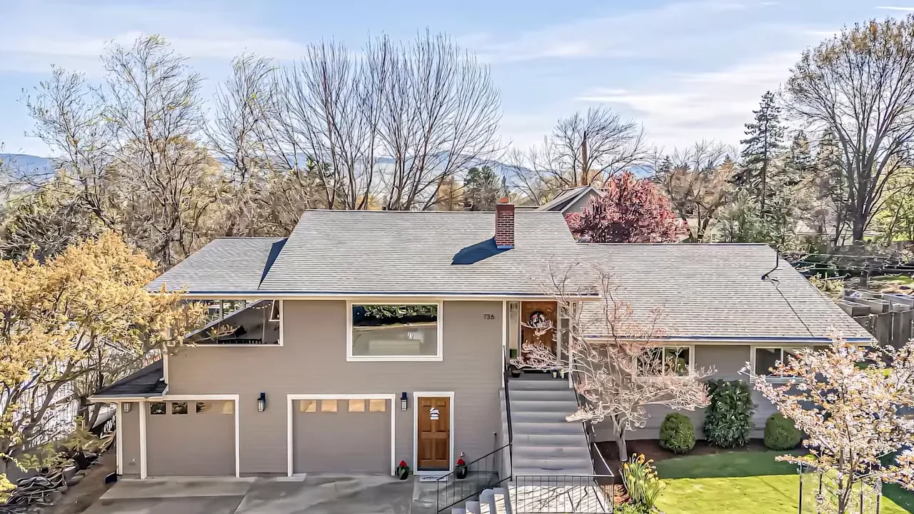 Single-family home exterior with attached garage and landscaped yard in Ashland Oregon