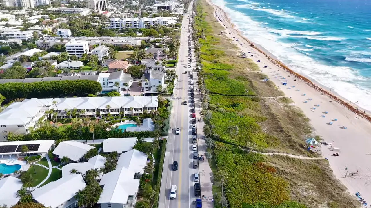 Aerial view of Delray Beach coastline showing Atlantic Avenue, beachfront homes, parking and ocean waves