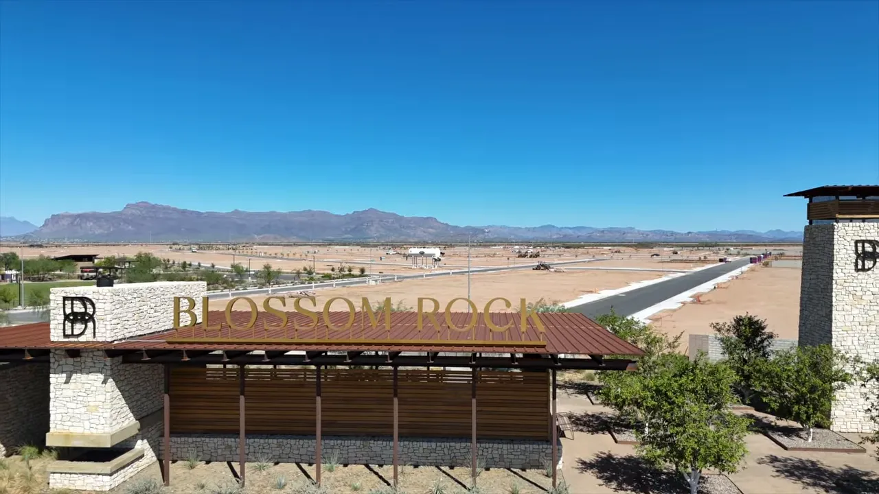 Blossom Rock entry structure and towers with large undeveloped land stretching behind it