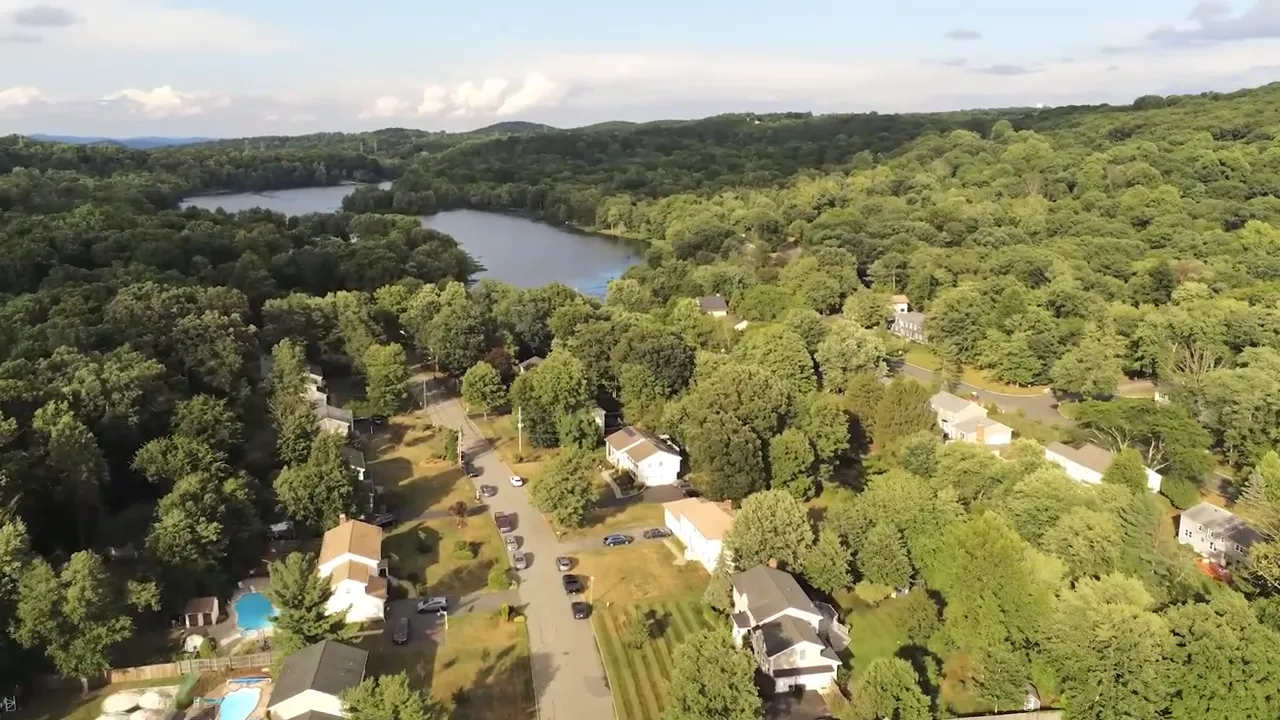 Wide aerial view of Shongum Lake surrounded by trees in Randolph, New Jersey
