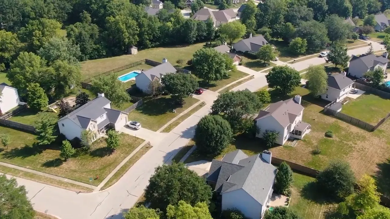 Aerial view of established neighborhood with mature trees detached homes and larger yards