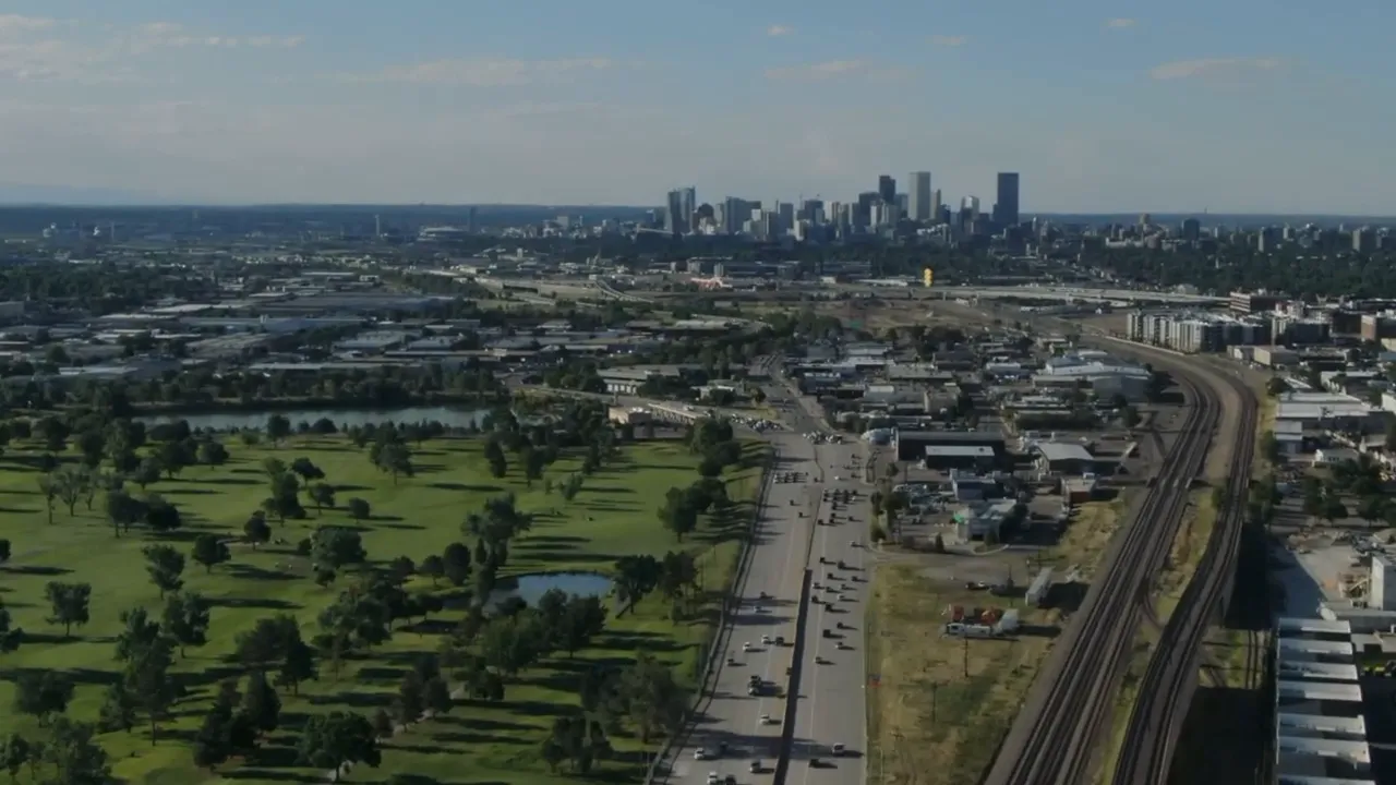Wide aerial view of traffic corridors leading into Denver metro