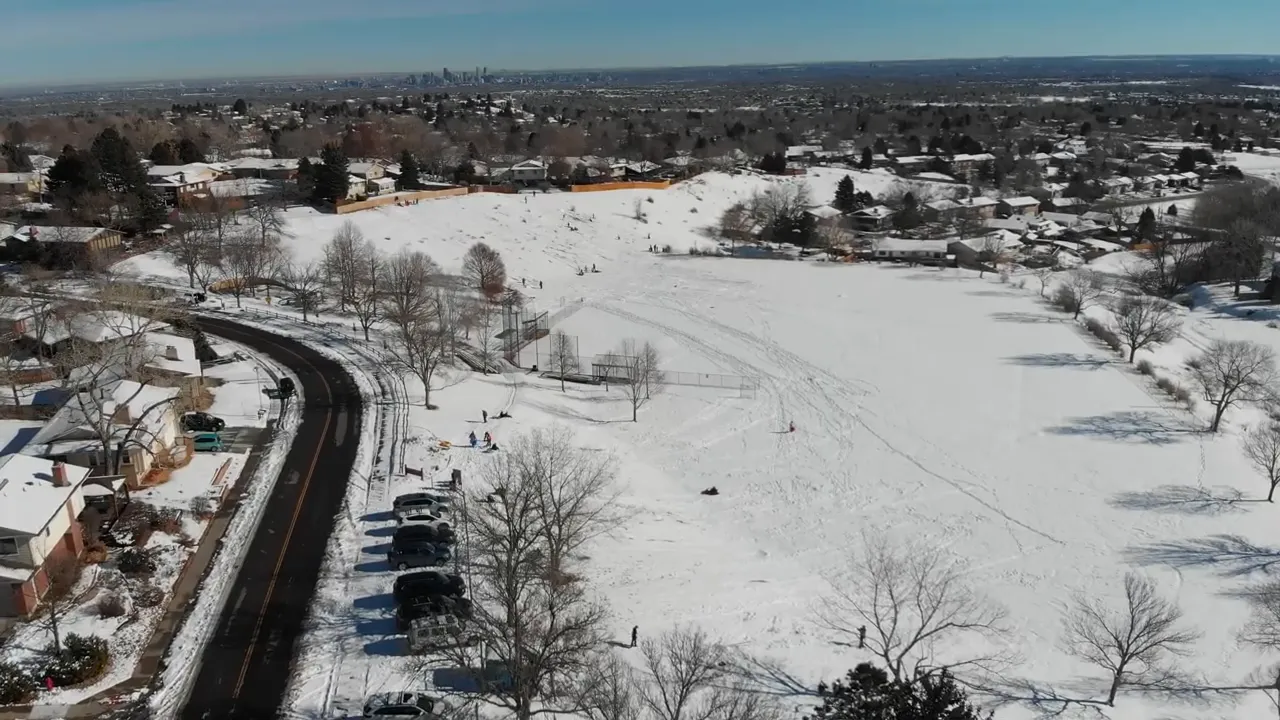 Wide aerial view of snow-covered roads, parks, and residential areas in Northern Colorado