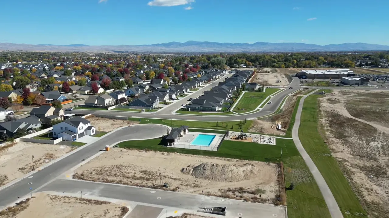Aerial view of Boise-area homes and roads showing nearby construction and undeveloped land