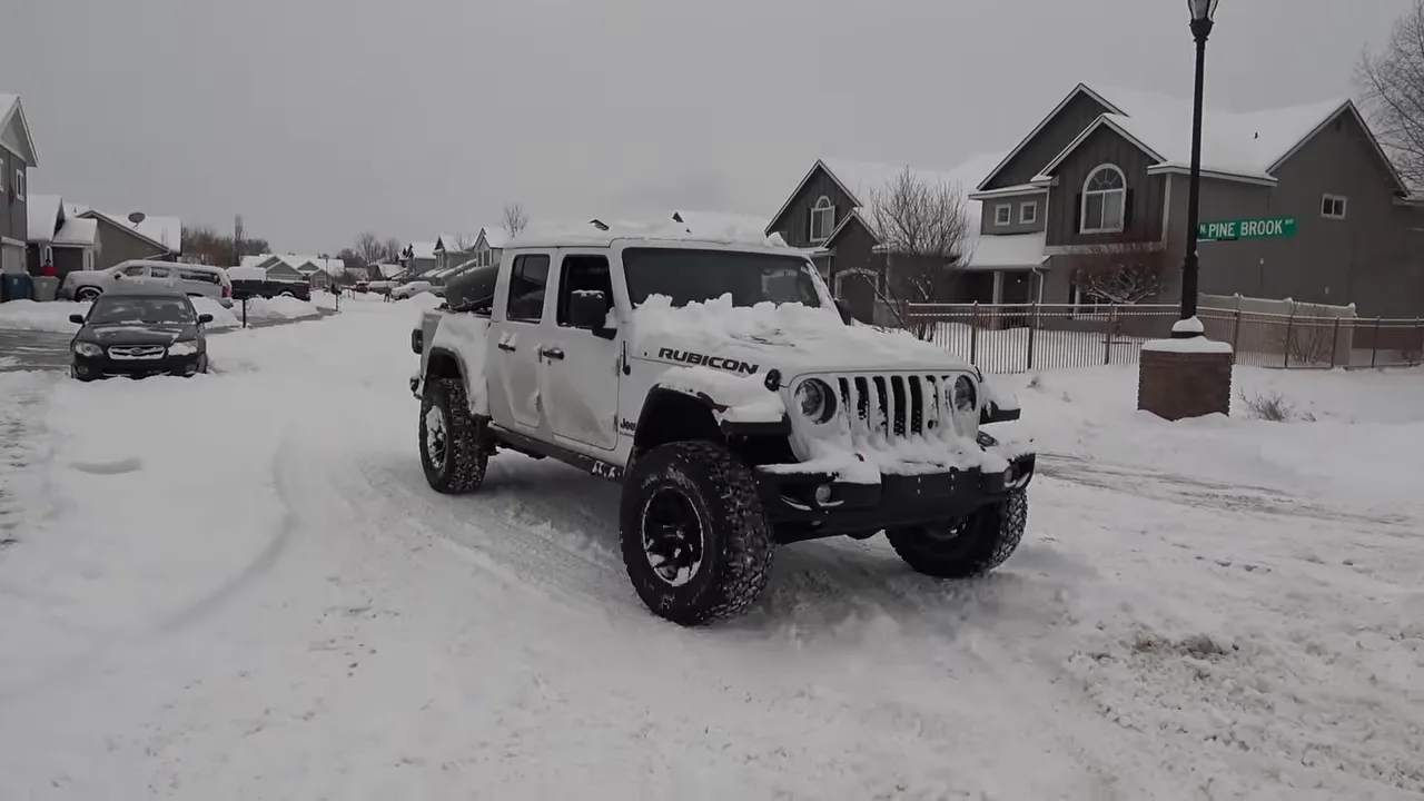 4x4 Jeep Rubicon parked on a snowy Boise neighborhood street
