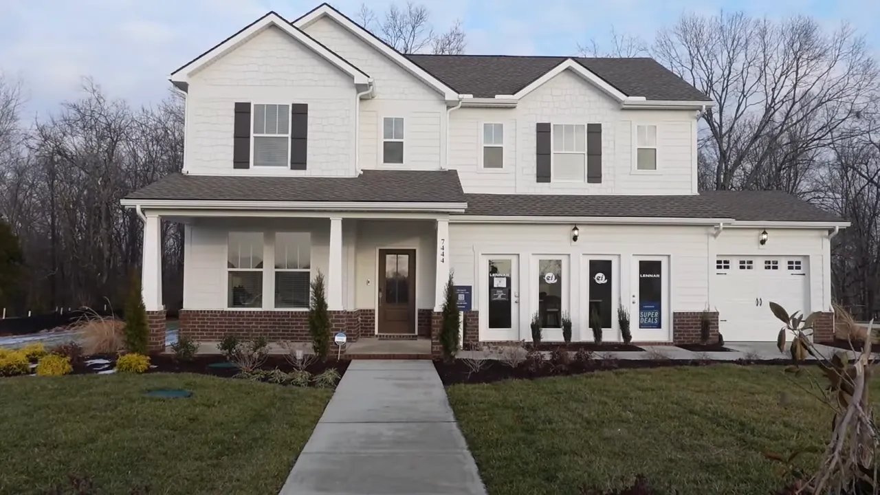 White two story home with covered front porch and three car garage