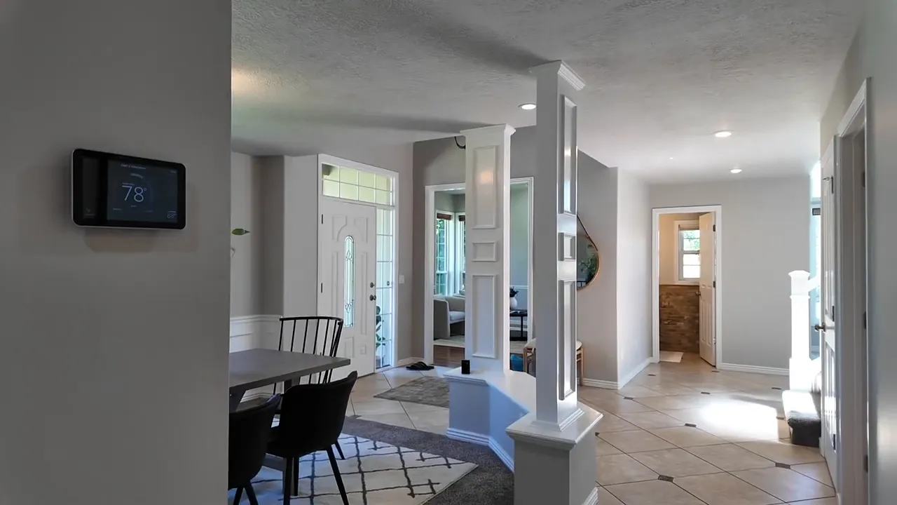 Bright home interior hallway with formal rooms and open doorway views