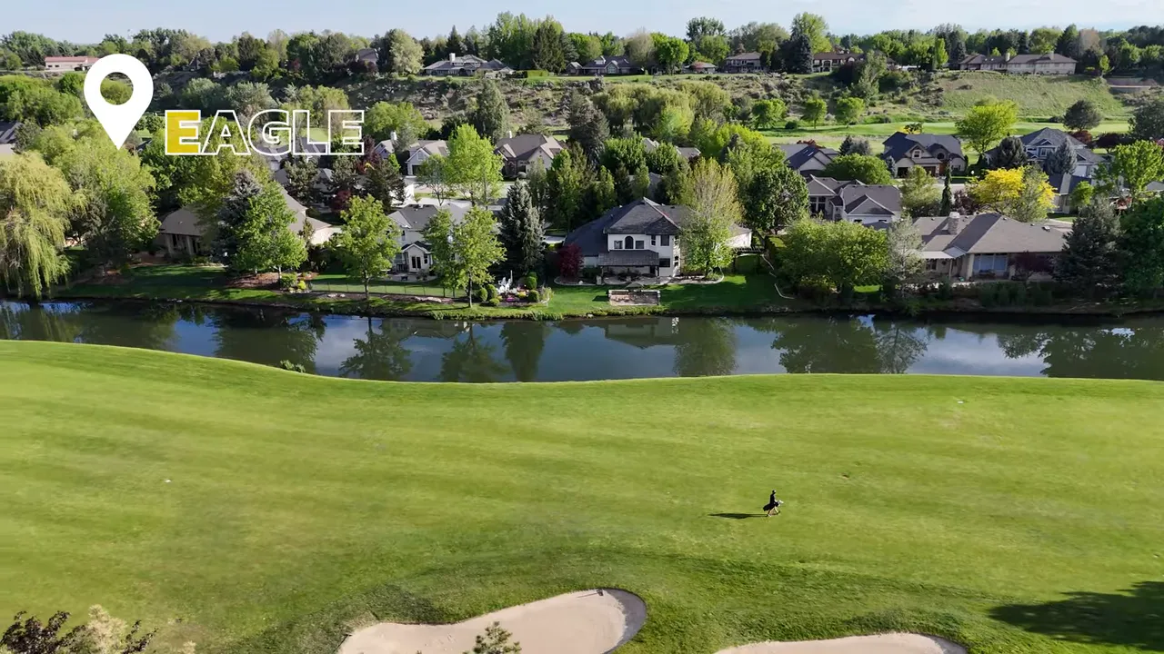 Aerial view of an Eagle, Idaho residential neighborhood with golf-course style landscaping and a pond