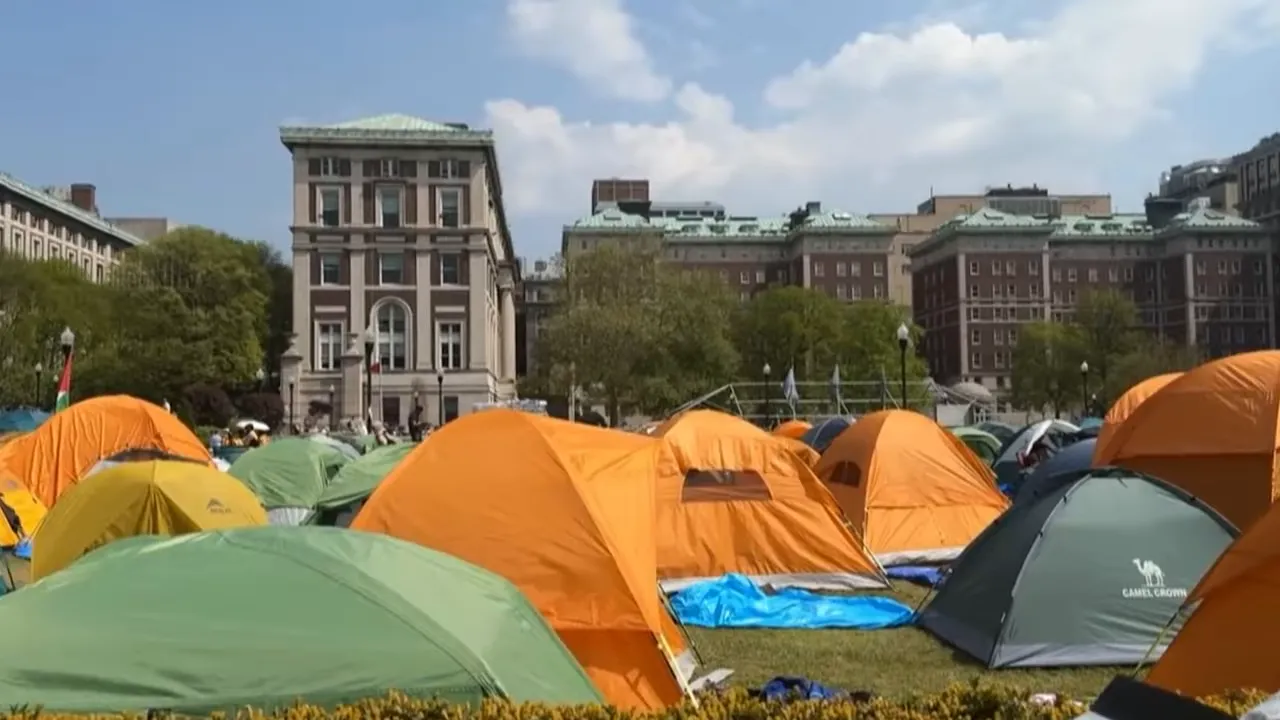 Camp of tents near buildings representing the homelessness crisis in Portland