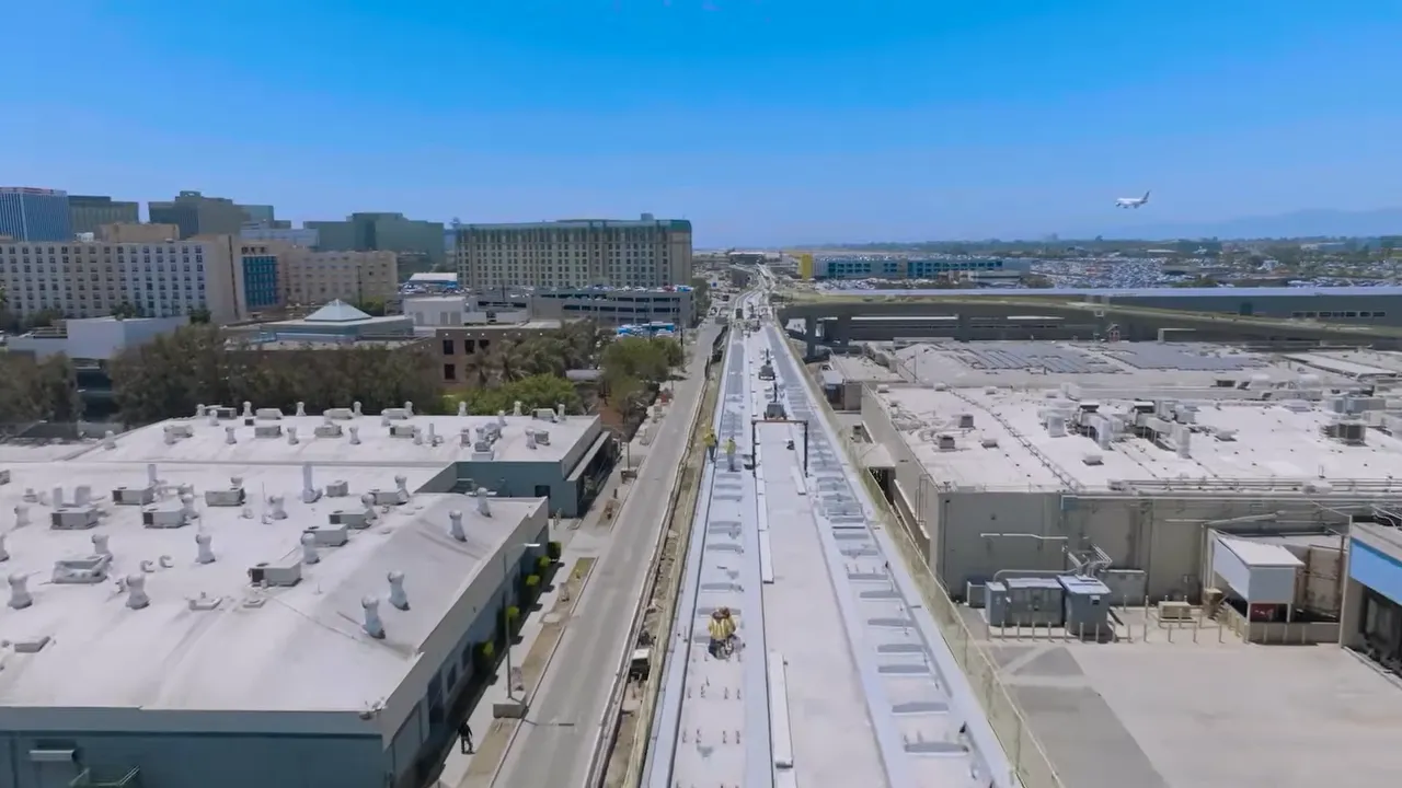 Aerial construction view of elevated guideway with text for automated people mover and 3 billion cost