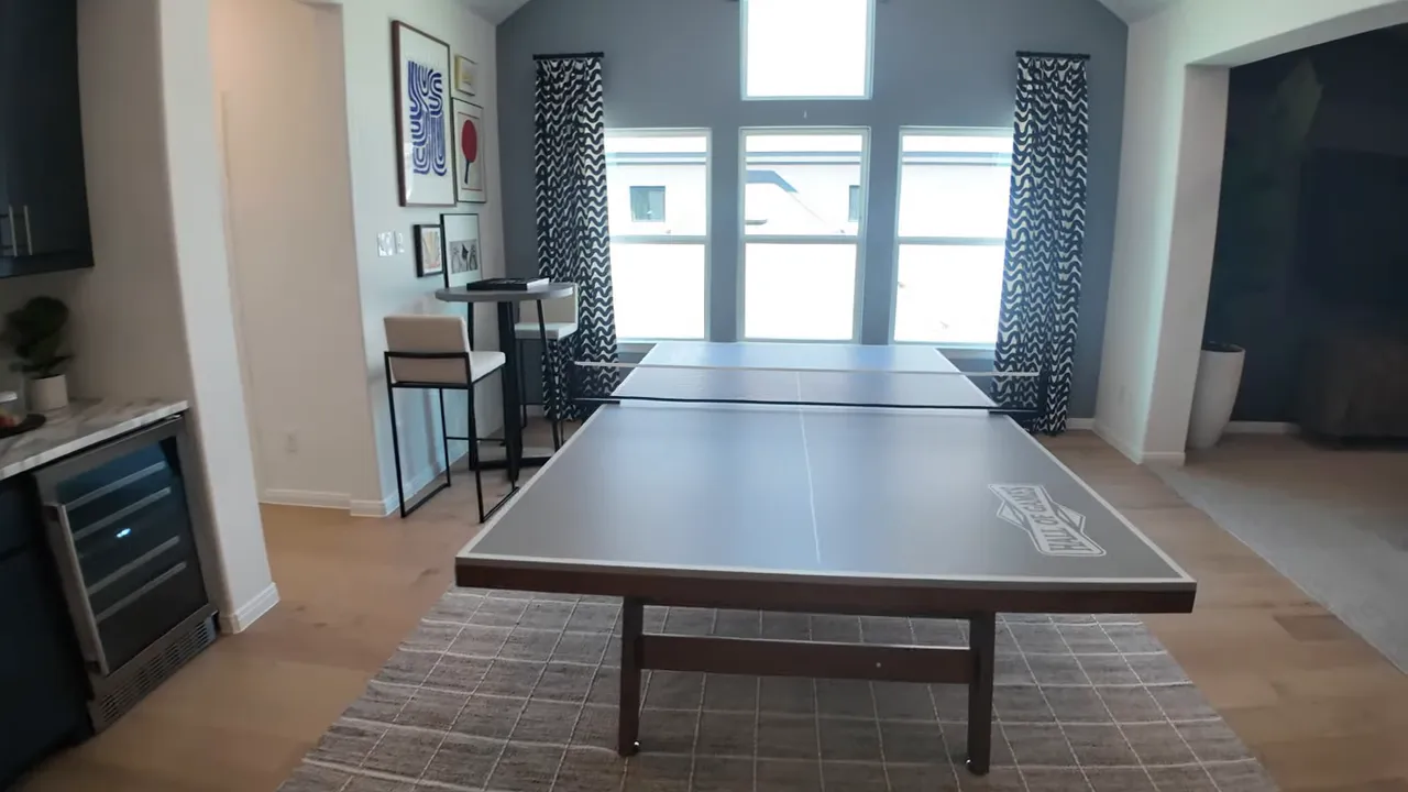 Game room with ping pong table and windows at the back wall