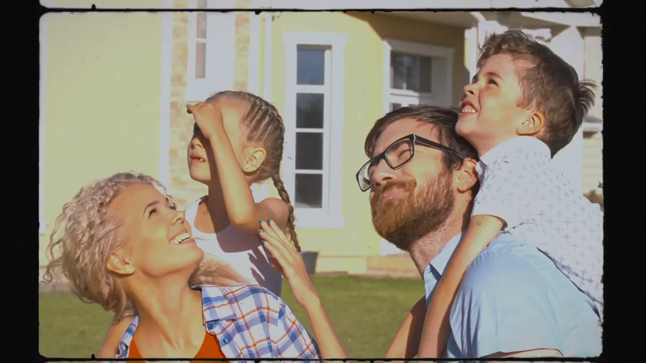 Smiling family outdoors in front of a house, representing families considering moving to Killeen, Texas