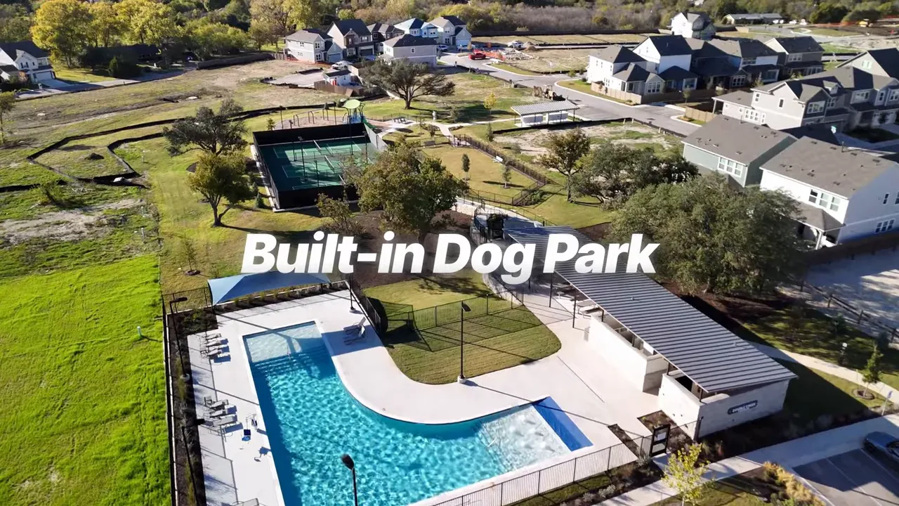 Aerial view of a community built-in dog park with pool, grass areas, and dog play spaces
