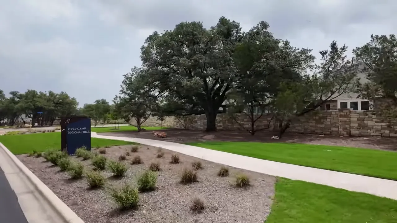Landscaped green space and walking path at Wolf Ranch in Georgetown, Texas