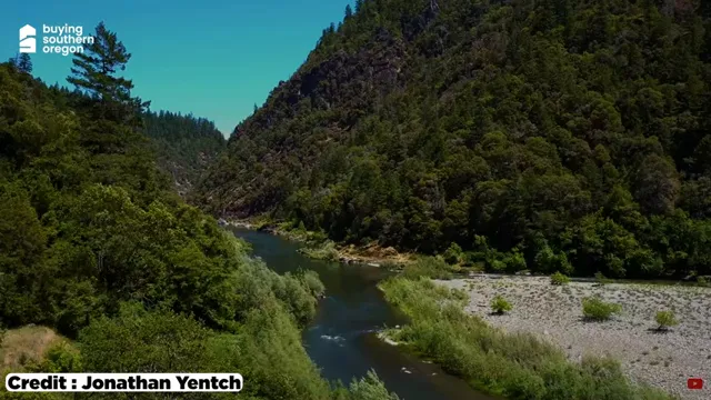 Raft carrying people through whitewater on the Rogue River