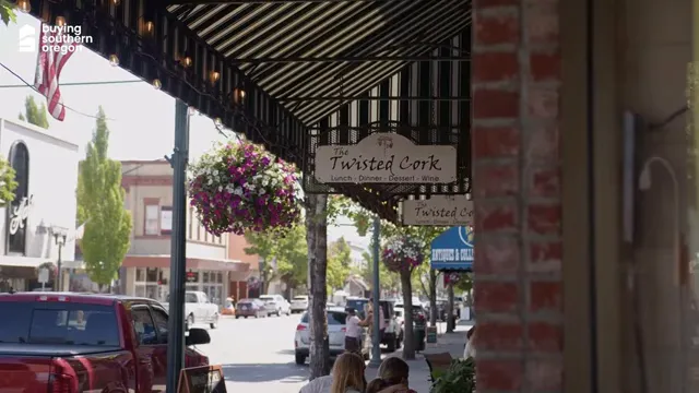 Twisted Cork sign hanging below a downtown sidewalk awning