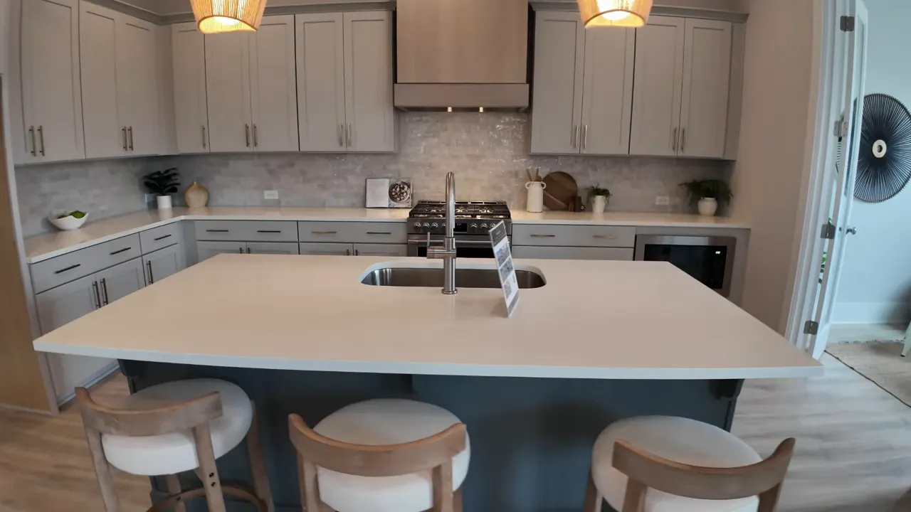 New construction kitchen with large island gray cabinets and gas range