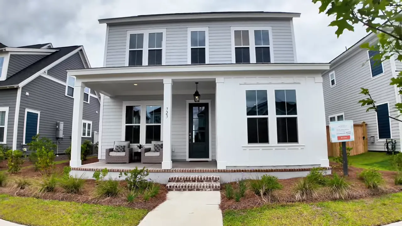 White new construction home with covered front porch and brick steps
