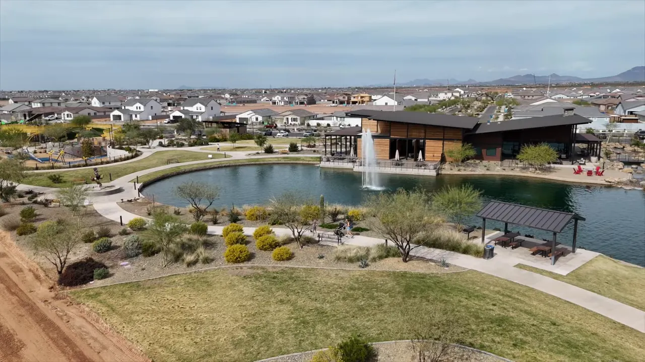 Aerial view of lake clubhouse paths and neighborhood homes