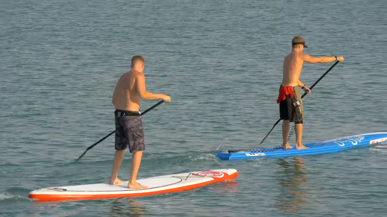 People paddle boarding on the ocean near Surfside Beach SC