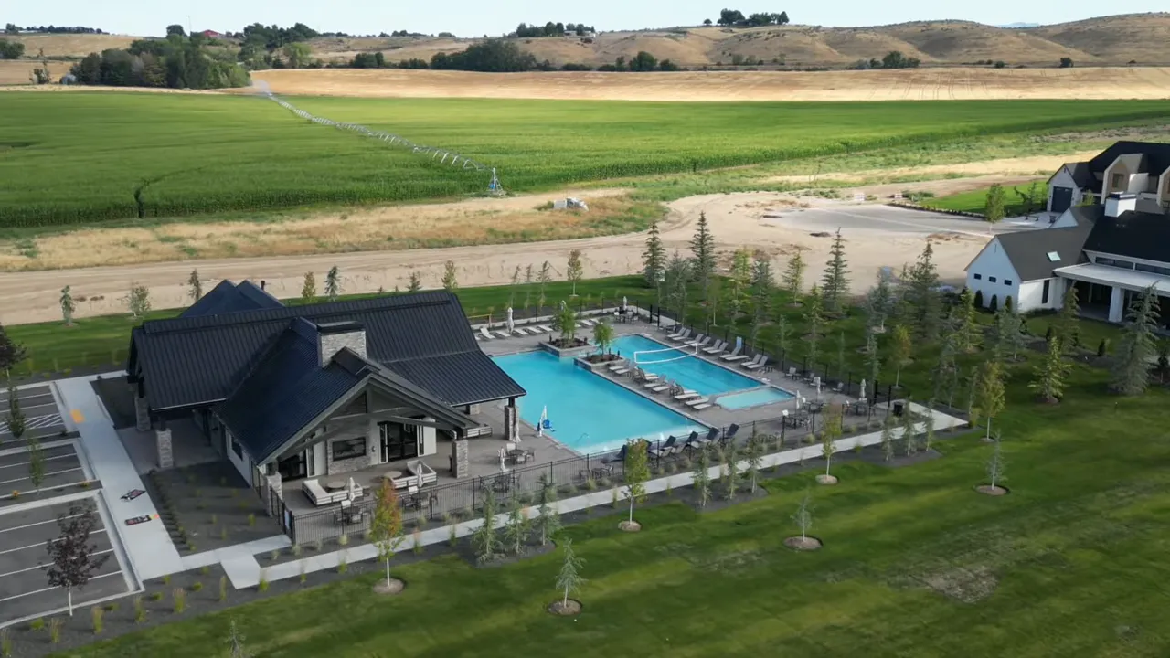 Large resort style pool with lounge chairs and landscaped surroundings