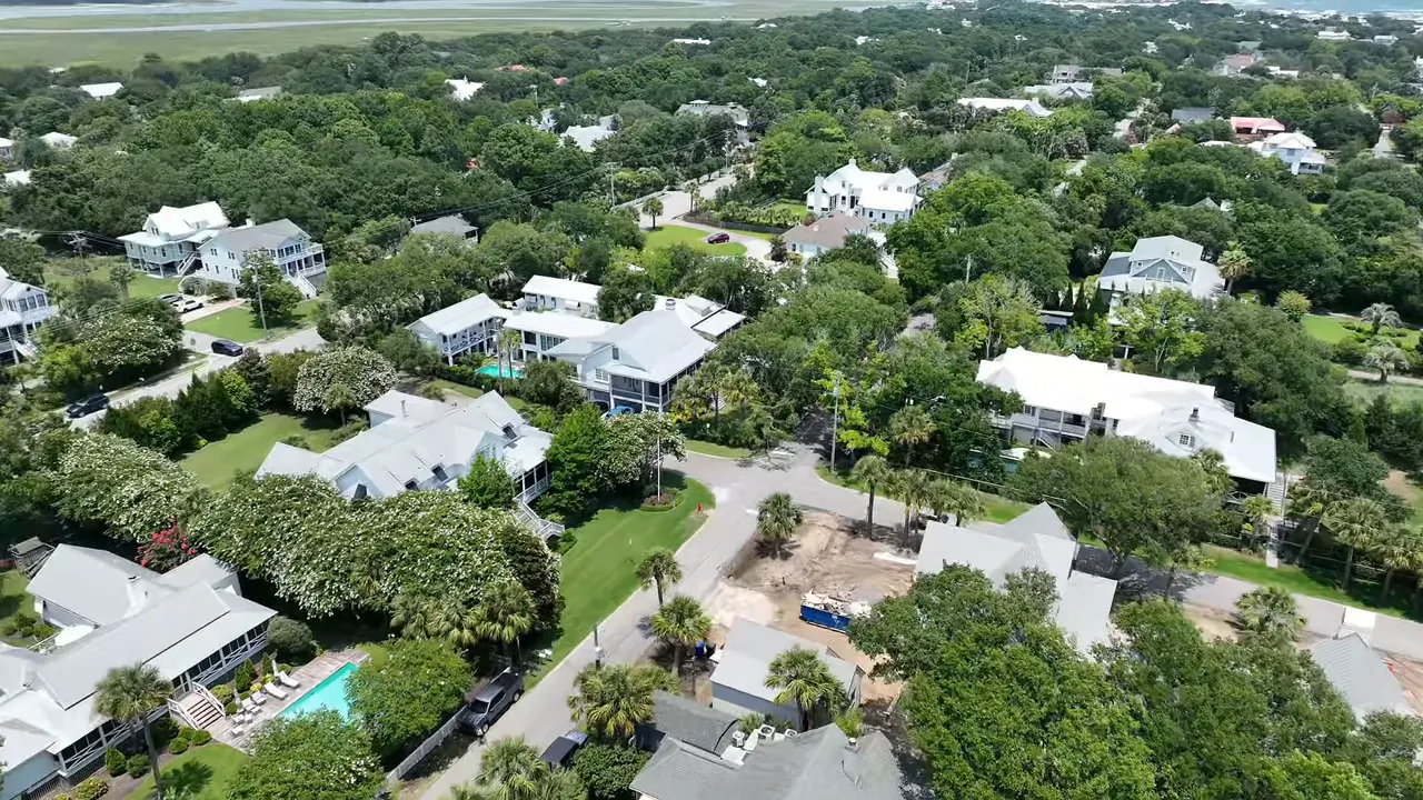Aerial neighborhood view with houses, trees, and pools in Summerville area