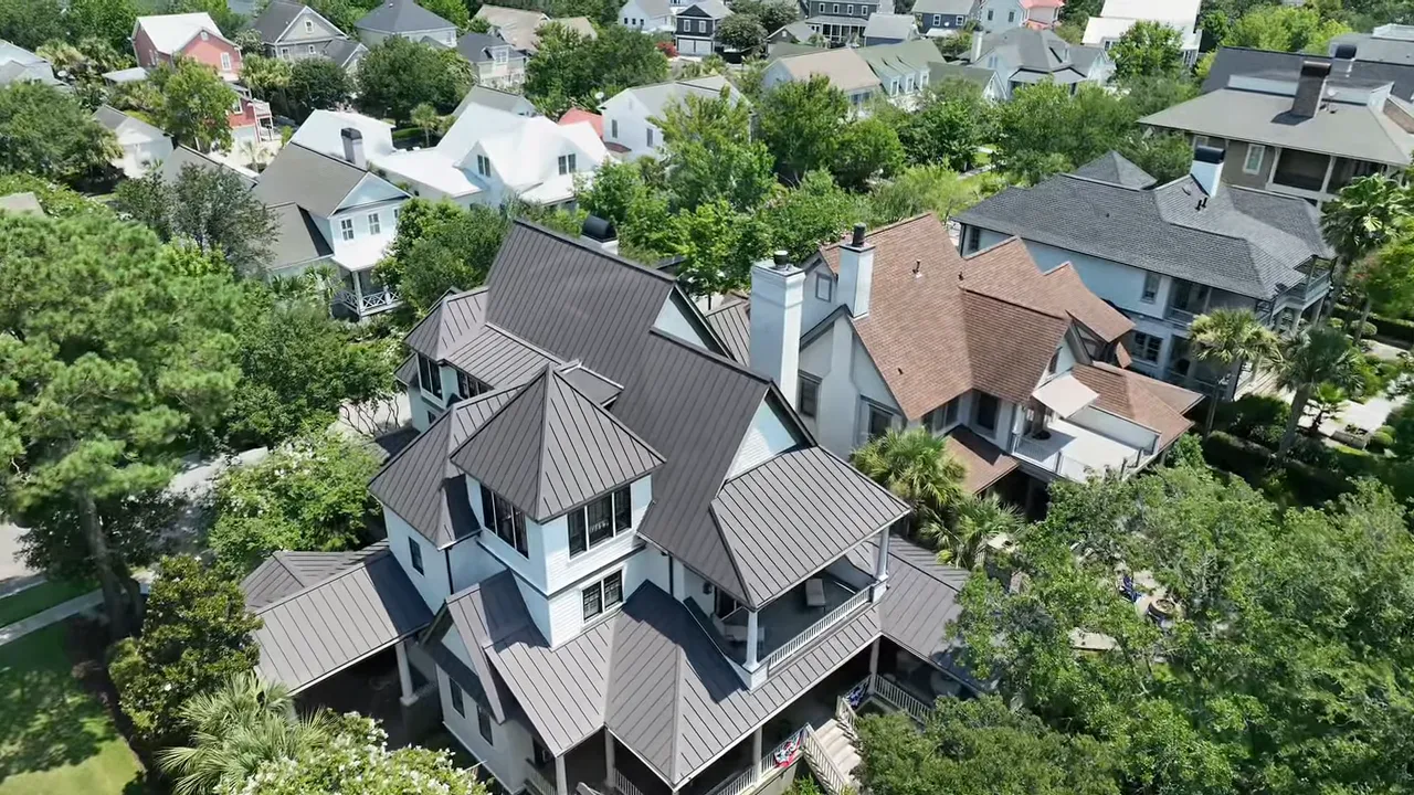 High-resolution aerial drone view of homes, roofs, and tree-lined streets in Summerville