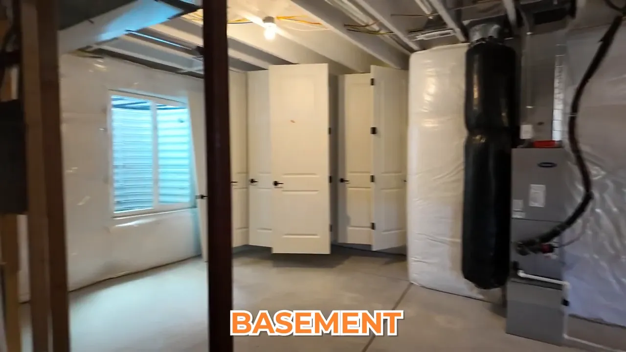 Unfinished basement interior with insulation-covered walls, mechanical area, and an open floor plan in Aurora Highlands