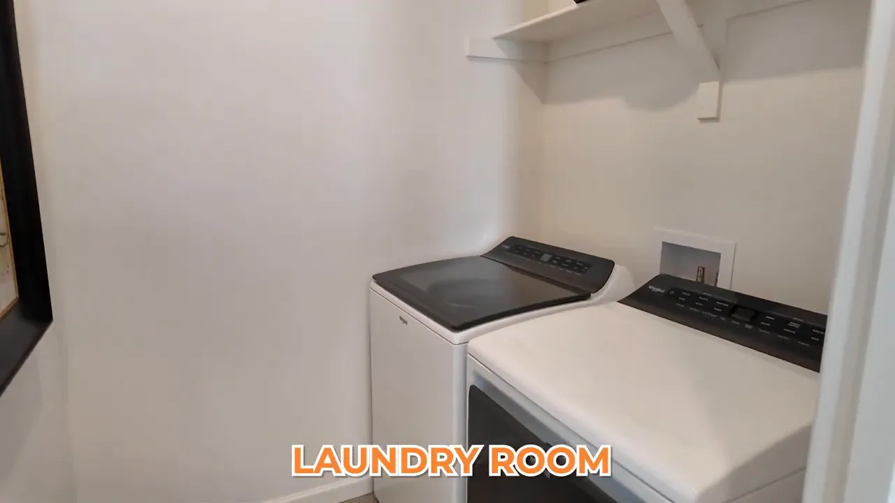 Upstairs laundry room with washer and dryer in Tri Pointe at Aurora Highlands model