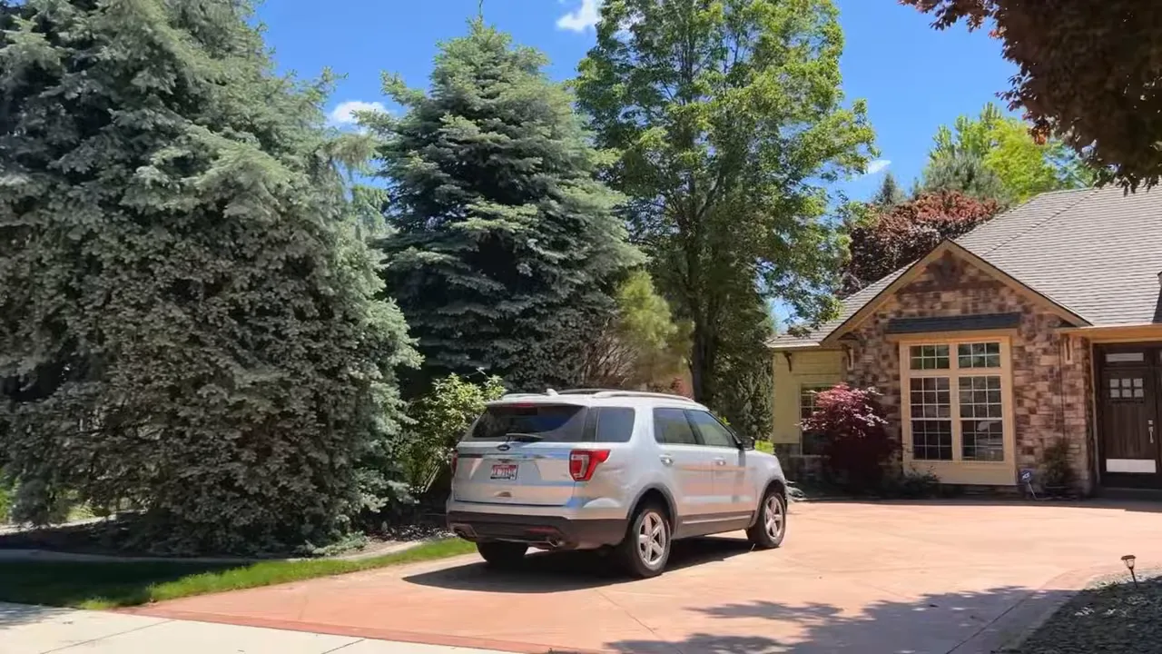 Luxury home driveway in Eagle, Idaho with a parked vehicle and landscaped front yard