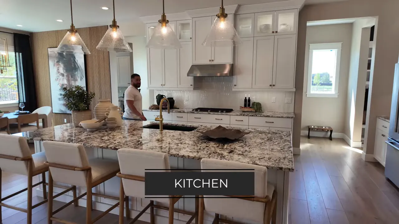 Luxury Eagle Idaho new construction kitchen with granite island, pendant lighting, and stainless range