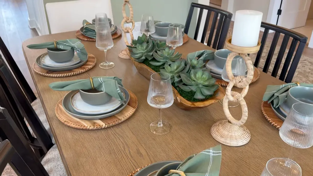 Formal dining table set beneath chandelier and wood tray ceiling
