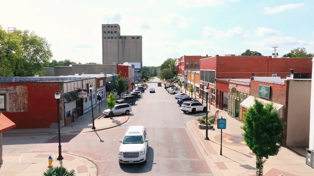 Aerial view of downtown Warrensburg streets storefronts and parked cars