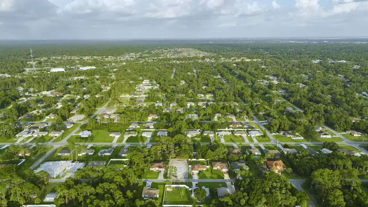 Aerial view of suburban neighborhood with text reading suburban